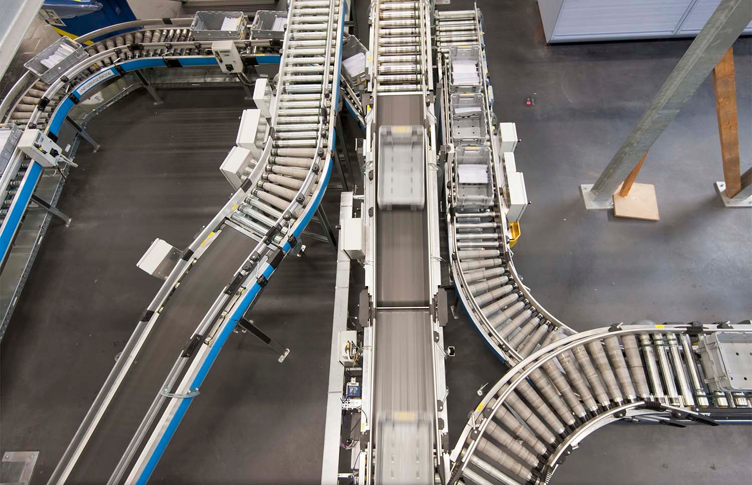Overhead view of empty conveyor belts in a factory