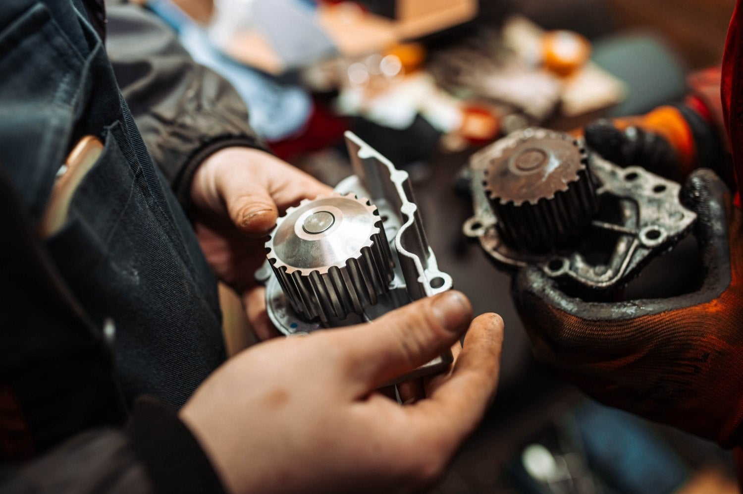 Close-up view of a technician holding machine parts