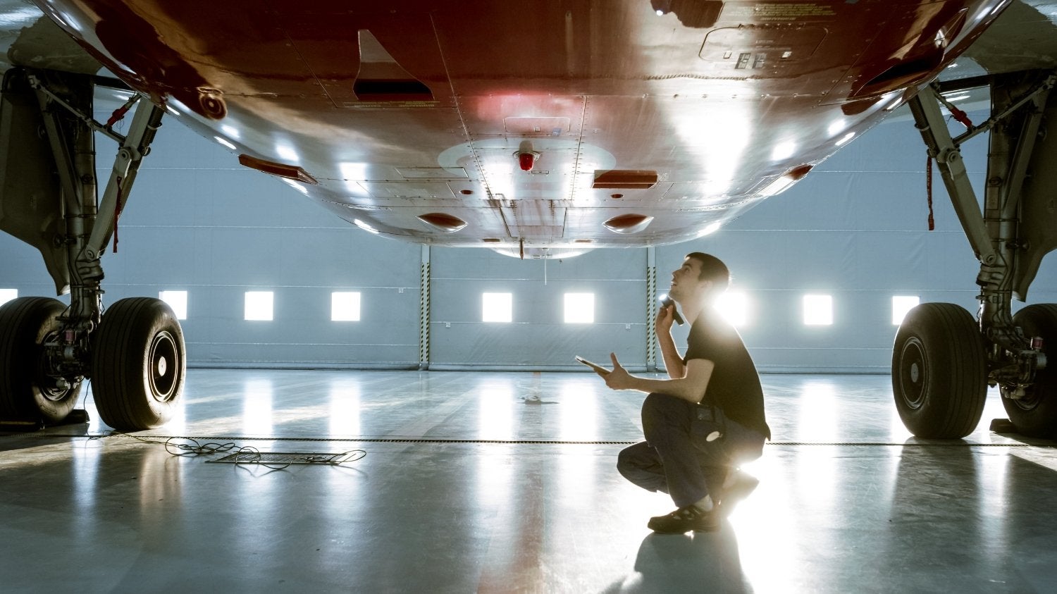 Airplane technician looking up at the plane