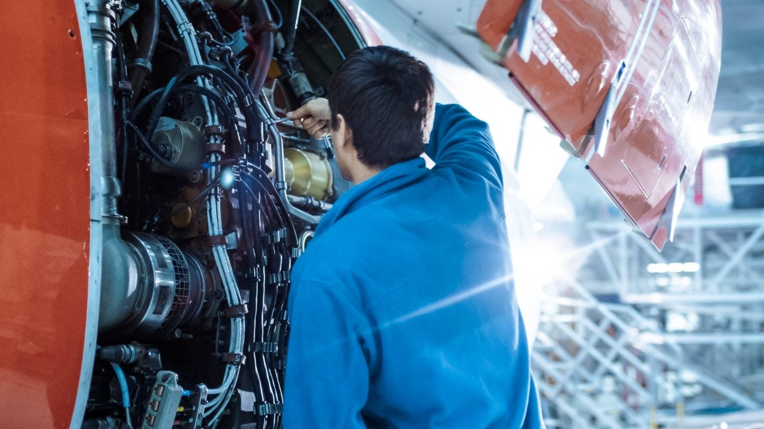 Airplane technician working on plane engine