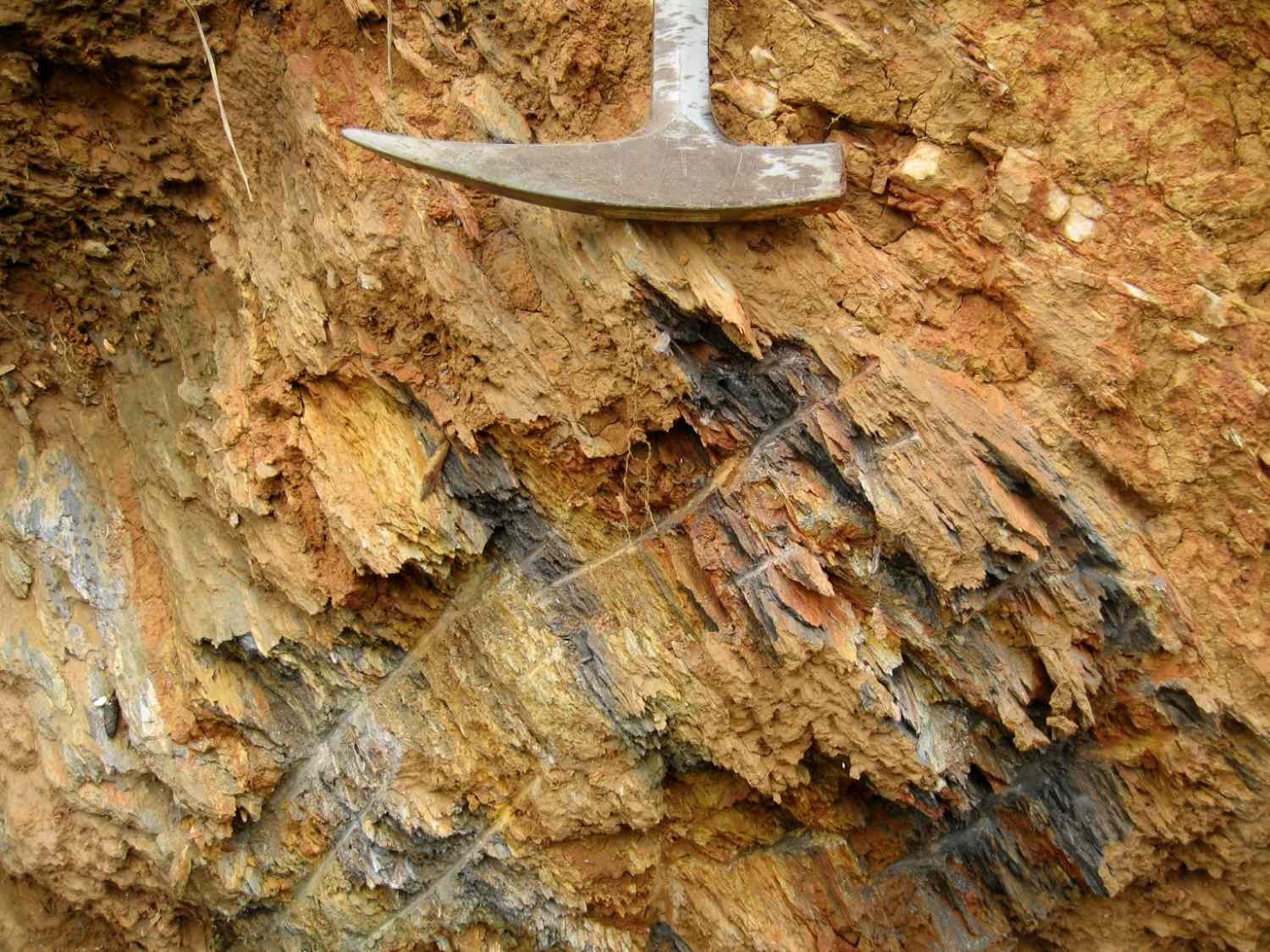 Pickaxe next to a wall of stone