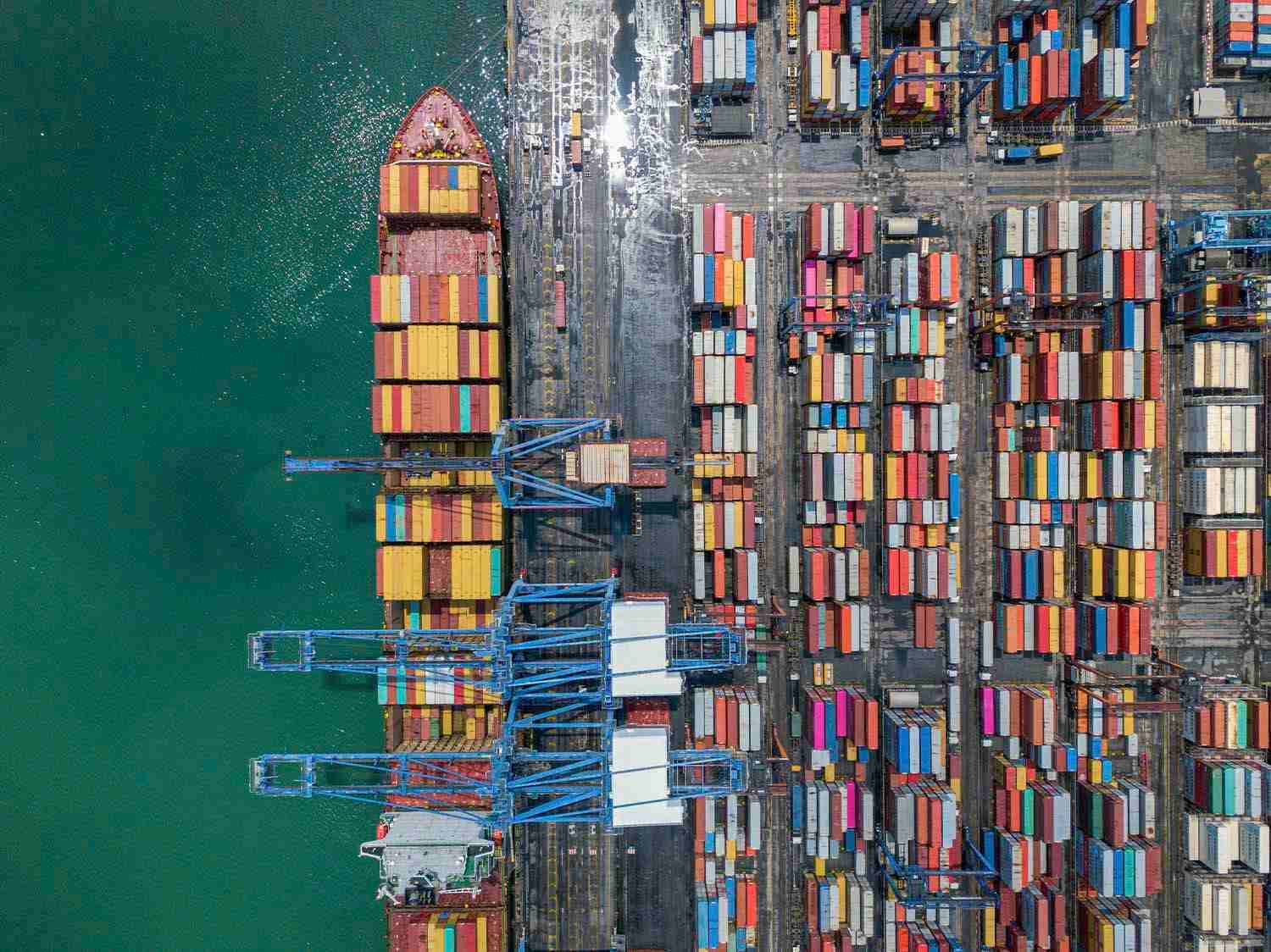 Overhead image of a cargo ship docked at a shipping yard