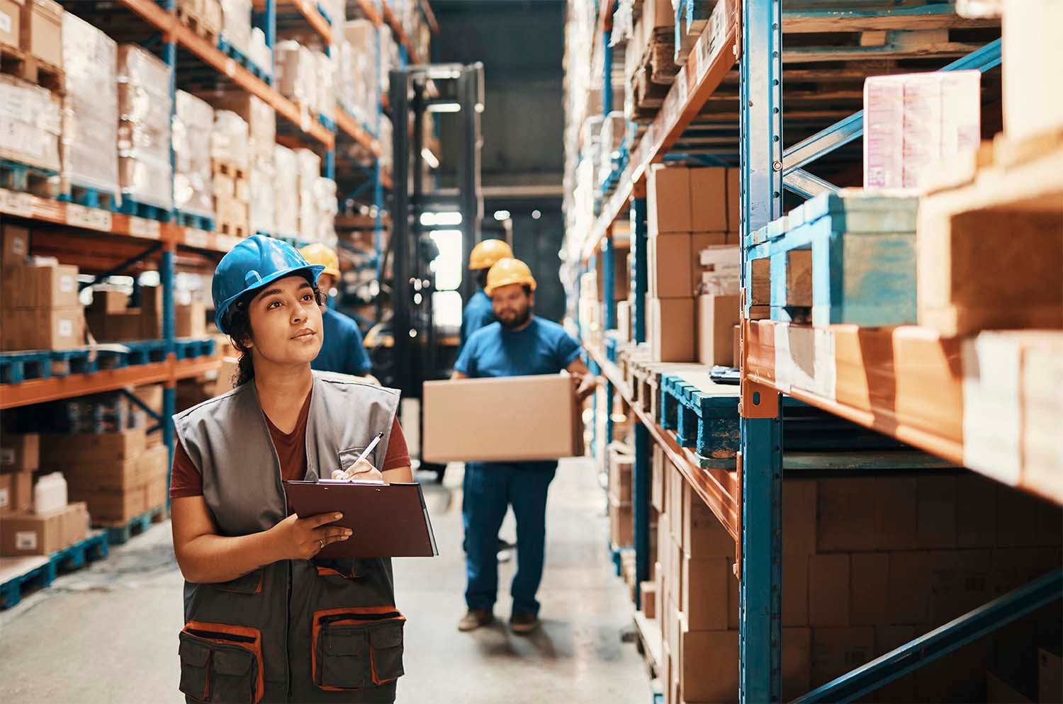 Warehouse worker taking inventory on clipboard
