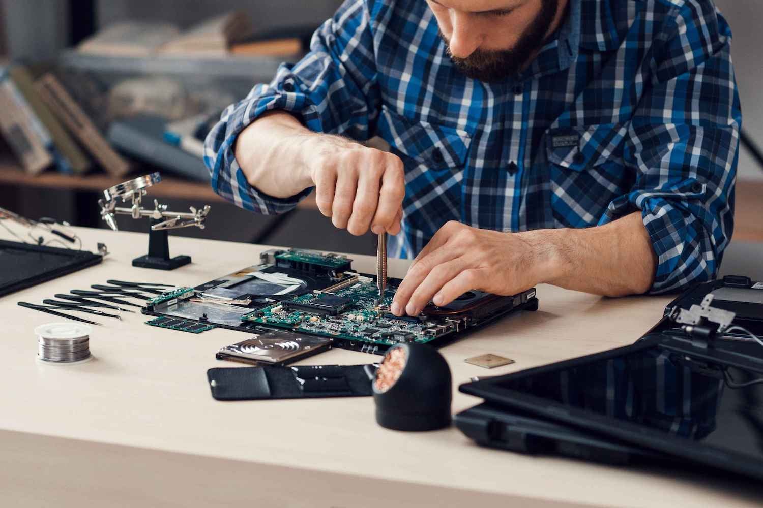 Technician working on electrical hardware