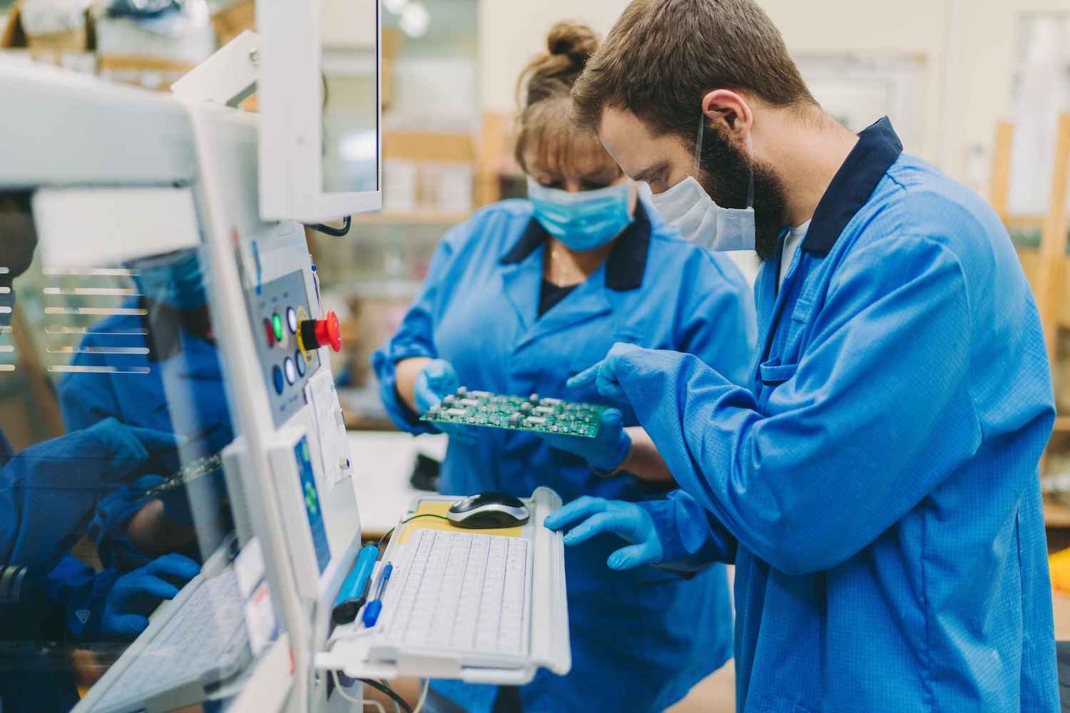 Two technicians working on electrical production