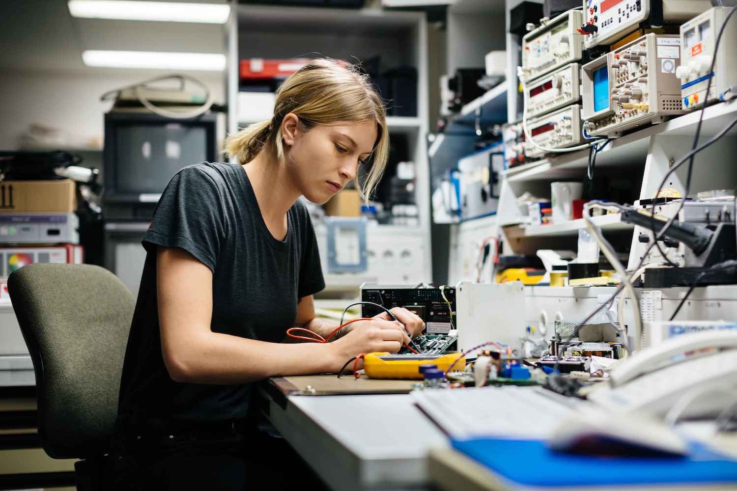 Technician wiring some electrical hardware