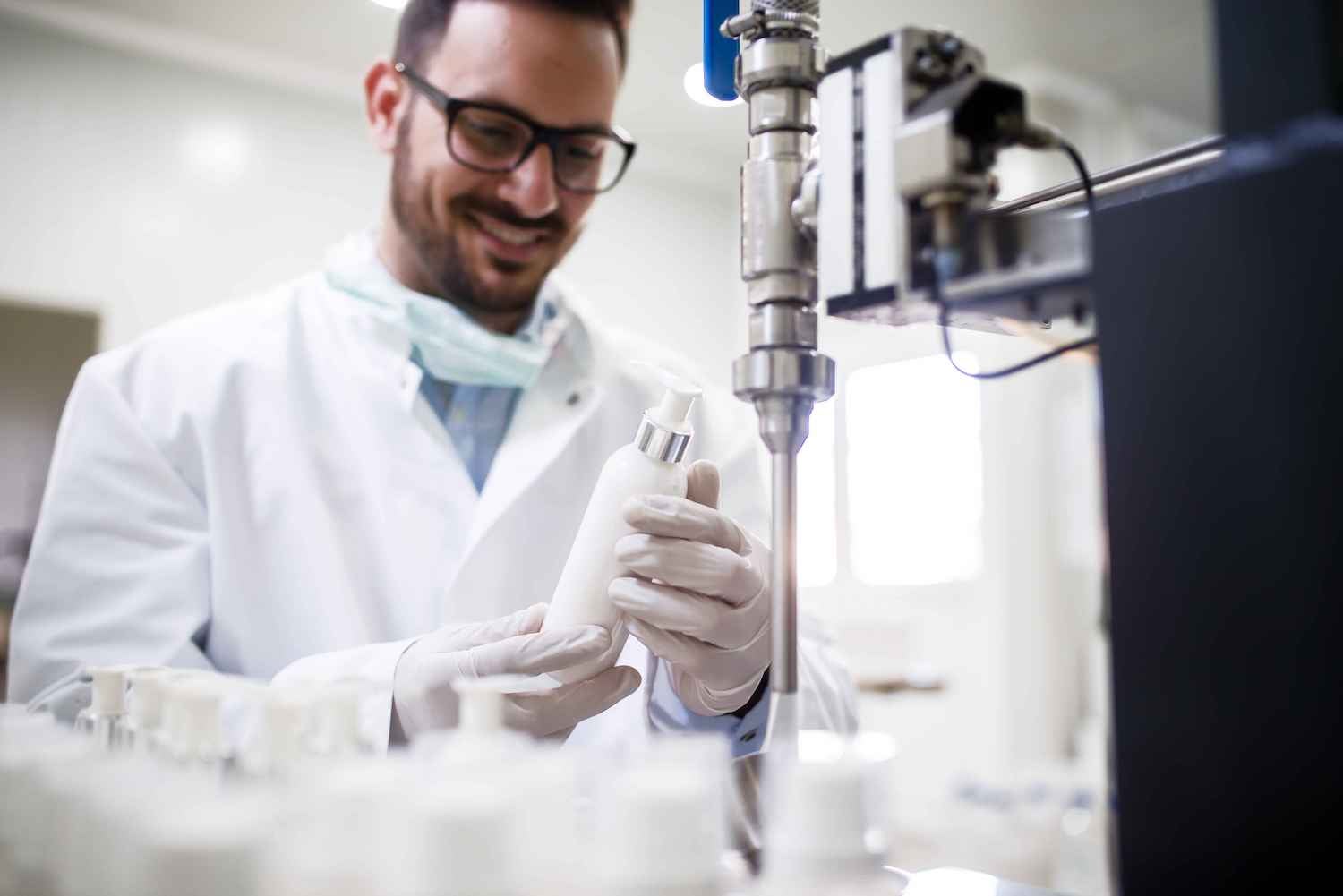 Medical employee filling bottles with medical device