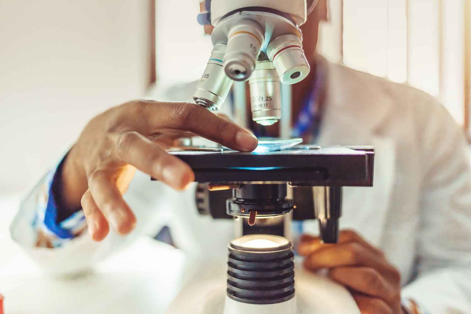 Doctor using a microscope to examine a medical specimen