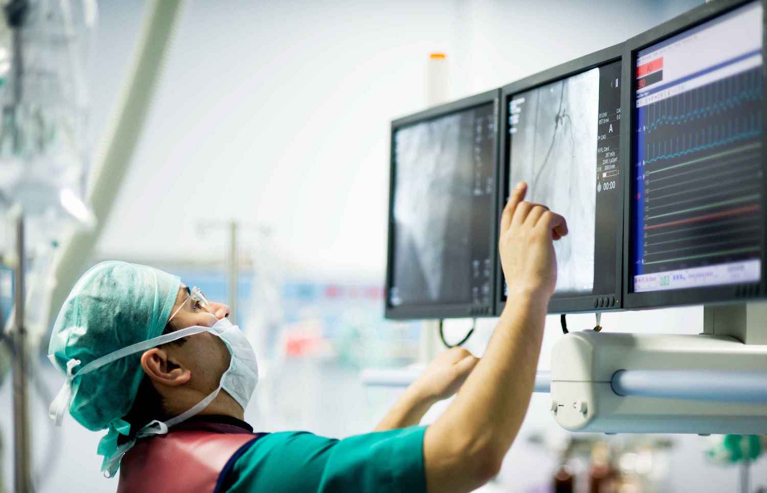 Doctor looking up at screens with x-rays