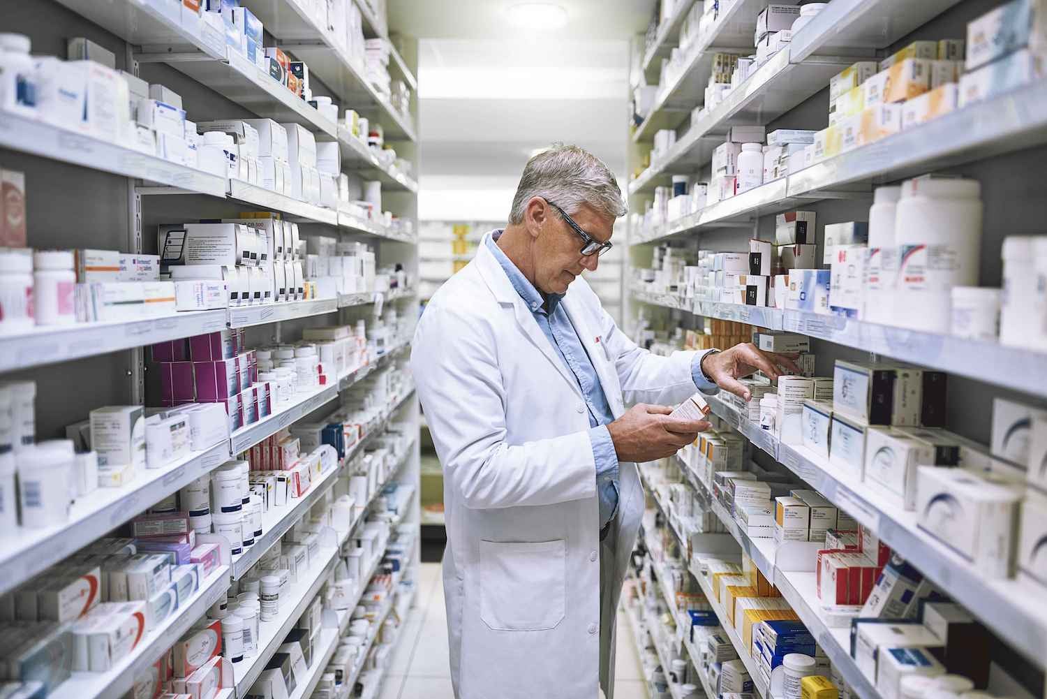 Medical employee examining products in a pharmacy setting