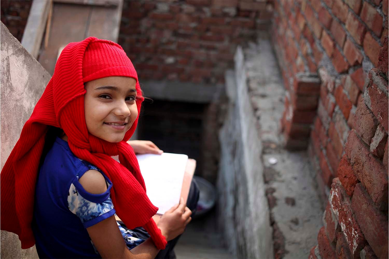 Smiling child working in a stairwell