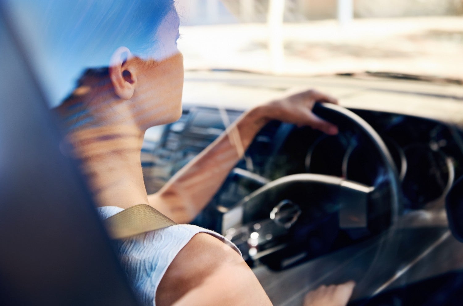 Over-the-shoulder image of a woman driving