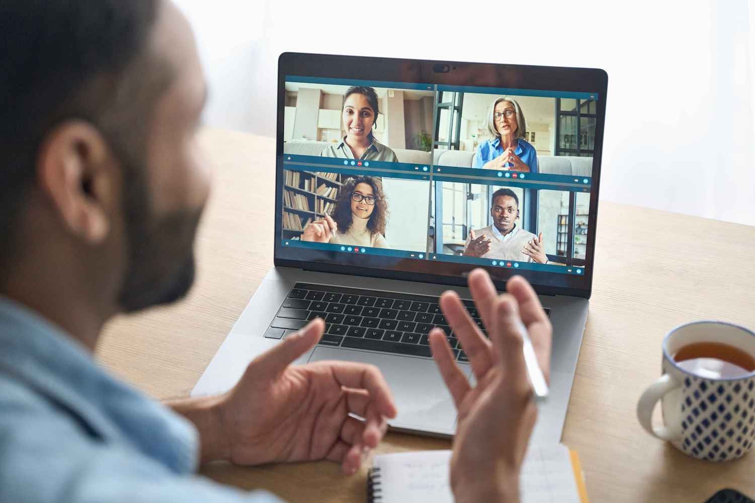 Over-the-shoulder image of a man on a video call