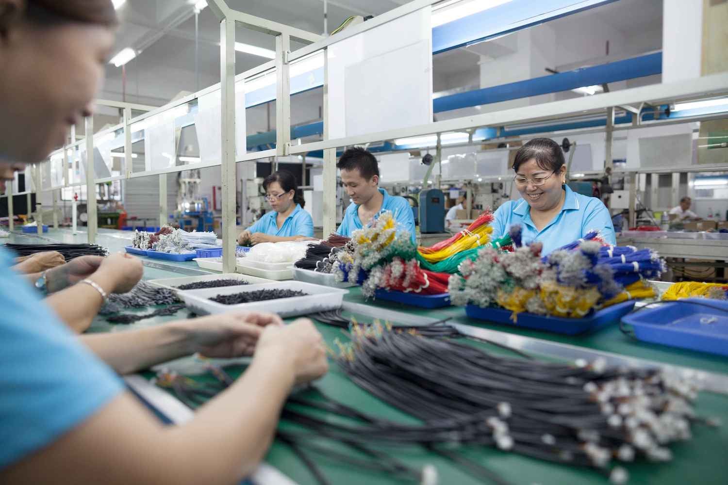 Image of industrial employees in an electrical factory setting