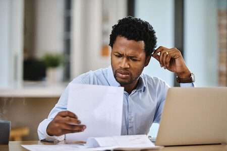 Man looking at compliance buzzwords with confusion.