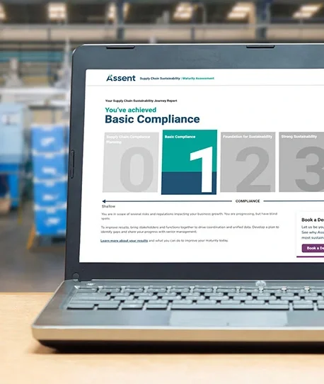 A laptop showing the Assent website on a compliance page