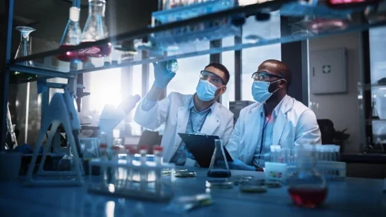 Two chemical engineers working on product design to account for PFAS regulations.