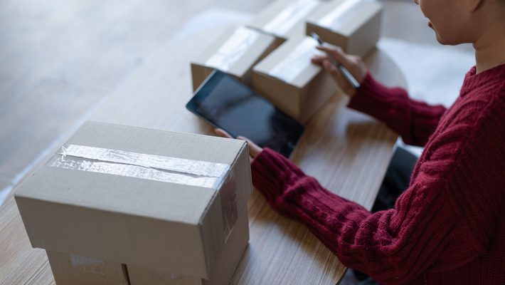 A person packaging goods for distribution, related to PPWR compliance.